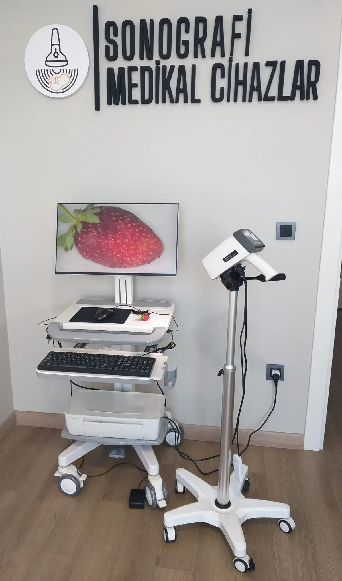 Our premises in Avcılar, İstanbul: the Sonografi Medikal Cihazlar sign on the wall, with a colposcopy system and workstation set up in front of it